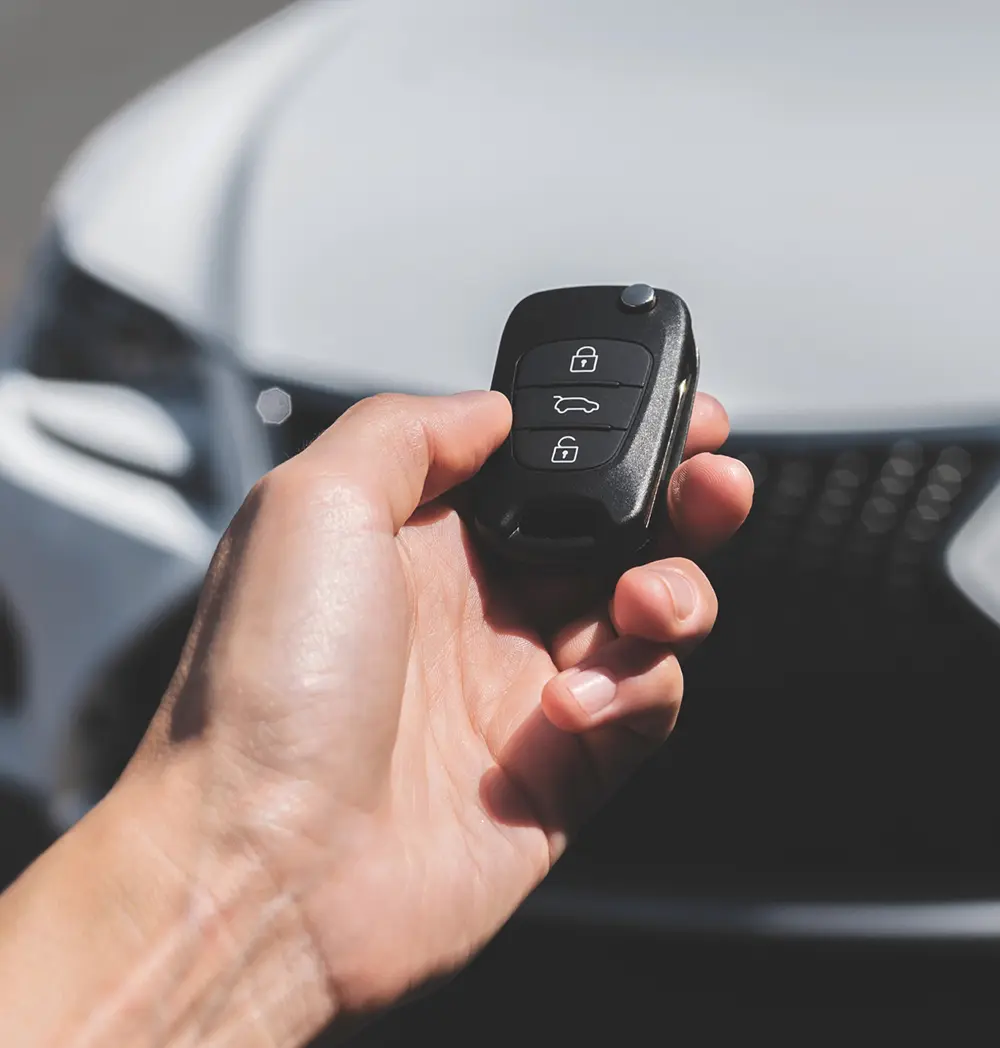 image of Hand holding a car key fob showing Key Fob Programming for CW Performance in Apex, NC