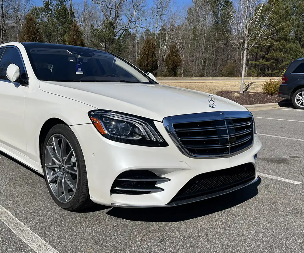 Luxury white Mercedes parked in lot at CW Performance in Apex, NC
