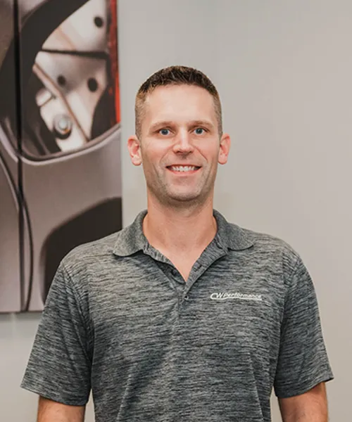 Smiling man in gray polo shirt