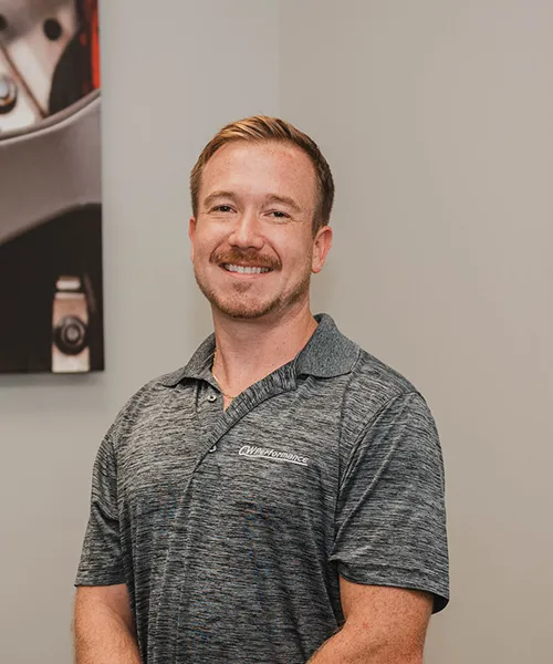 Smiling man in gray polo shirt