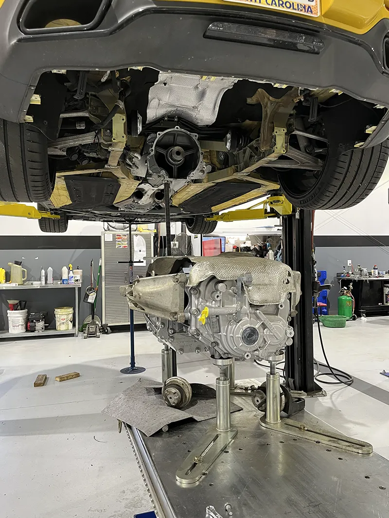 Car lifted with engine removed underneath