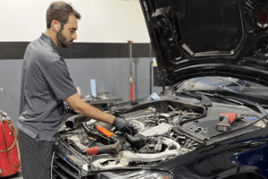 Cooling system inspection, auto repair in Apex, NC, at CW performance.Image of an auto technician inspecting and servicing a vehicle's cooling system under the hood to diagnose coolant leaks, overheating issues, and cooling system performance.