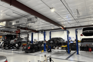 Car maintenance, auto repair in Apex, NC at CW Performance. Image of a modern service facility with multiple European vehicles receiving professional diagnostics, maintenance, and repair.
