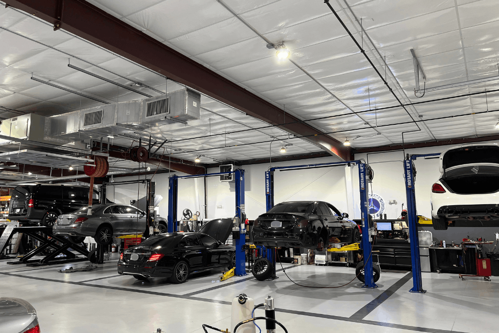 Car maintenance, auto repair in Apex, NC at CW Performance. Image of a modern service facility with multiple European vehicles receiving professional diagnostics, maintenance, and repair.